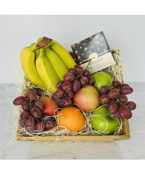 Gift basket filled with assorted fresh fruit and gourmet treats.