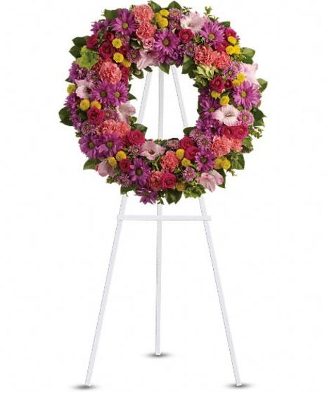 Floral wreath in hues of red, purple, pink and green.