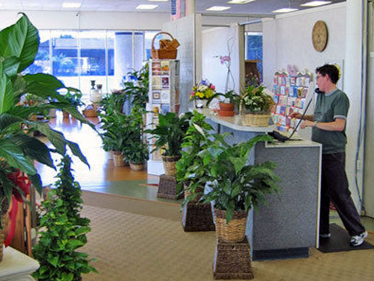 A member of the Bice's staff, waiting to help at the customer service desk